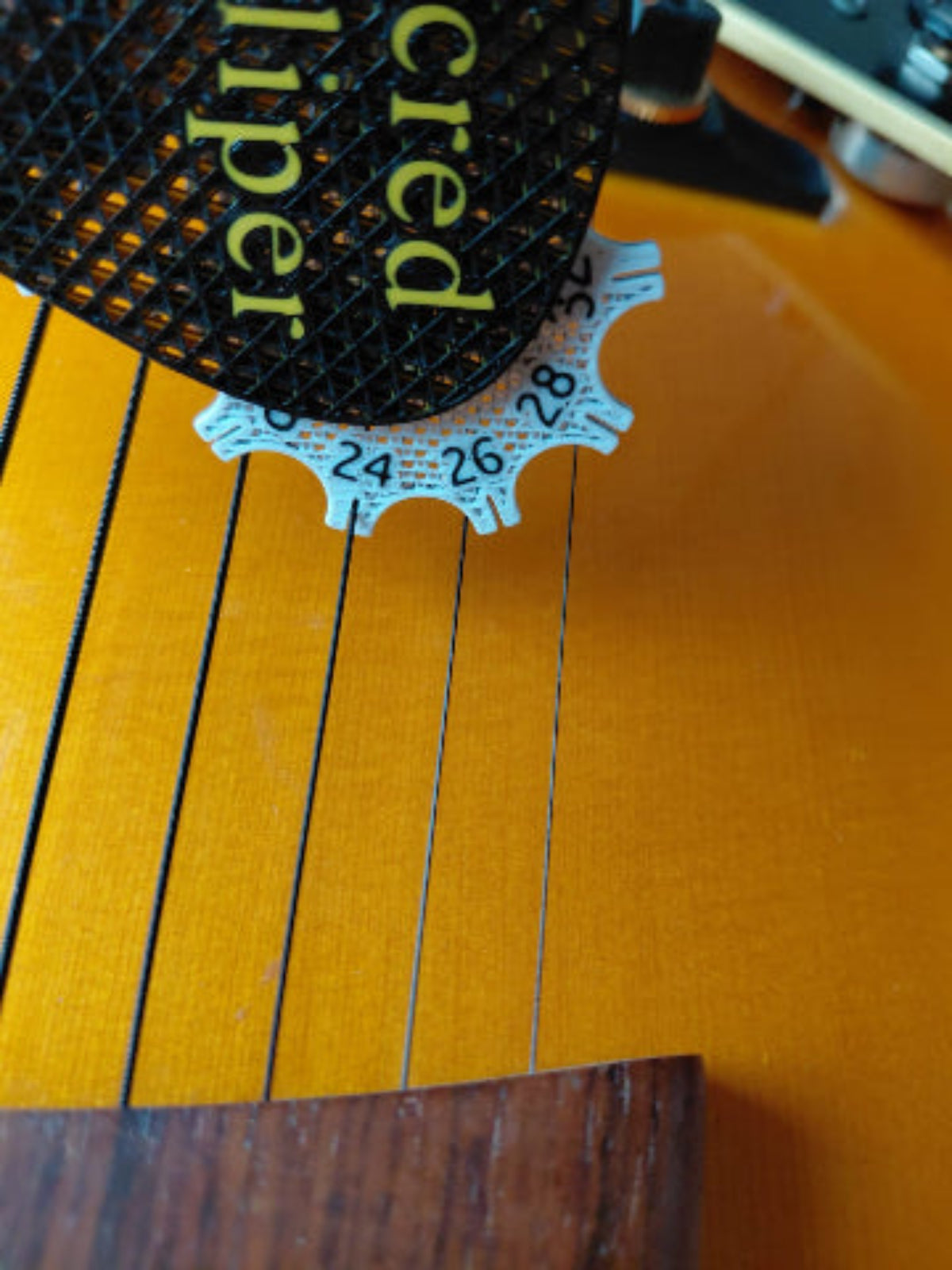 Sacred Kaliper Guitar String Gauge Tool.